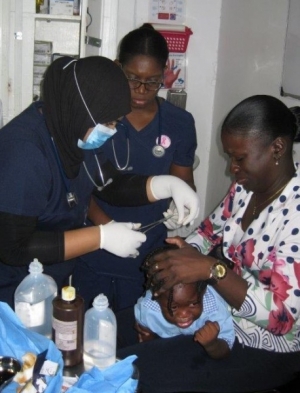 Photo 5 Residency director supervising pediatric suturing